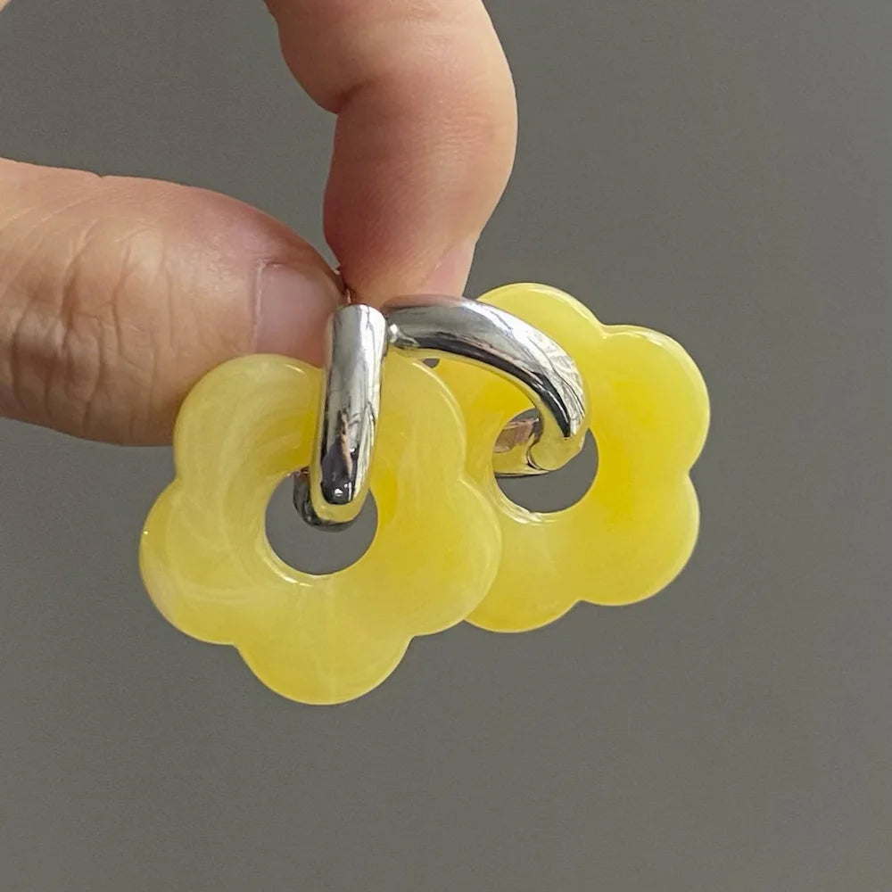 Korvakorut, joissa on kukkakuvioinen resiinisormus