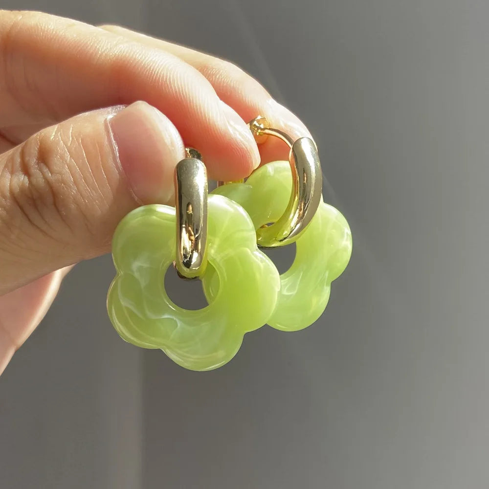 Korvakorut, joissa on kukkakuvioinen resiinisormus