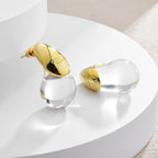 Korvakorut läpinäkyvällä vesipisaran nastalla kulta