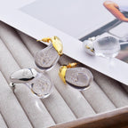 Korvakorut läpinäkyvällä vesipisaran nastalla kulta