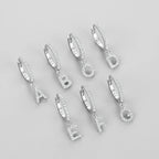 Korvarenkaat alkukirjaimella