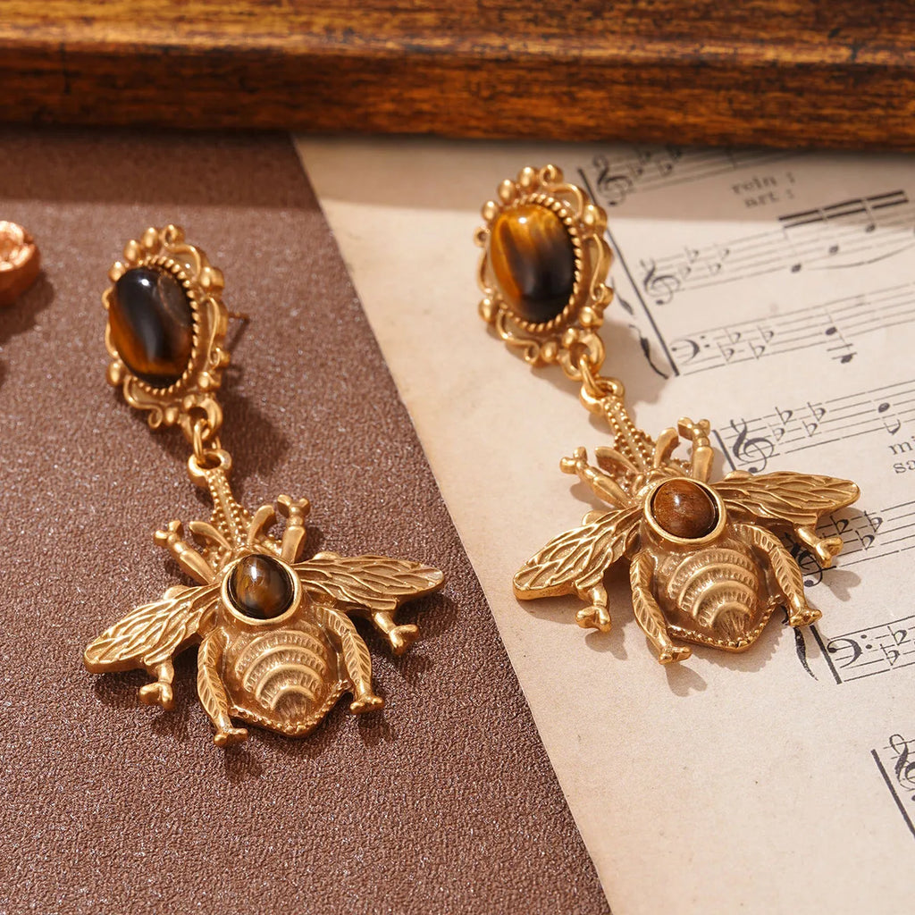 Riippuvat mehiläiskorvakorut tiikerinsilmä