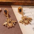 Riippuvat mehiläiskorvakorut tiikerinsilmä