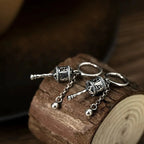 Riipuskorvakorut, buddhalainen rukouspyörä