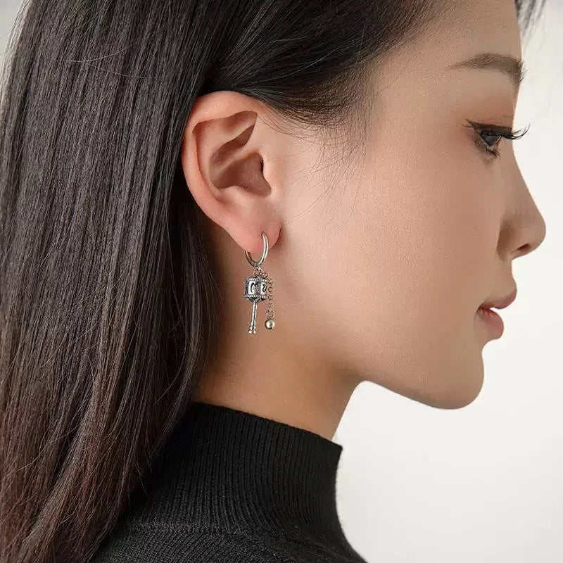 Riipuskorvakorut, buddhalainen rukouspyörä