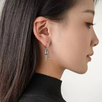 Riipuskorvakorut, buddhalainen rukouspyörä