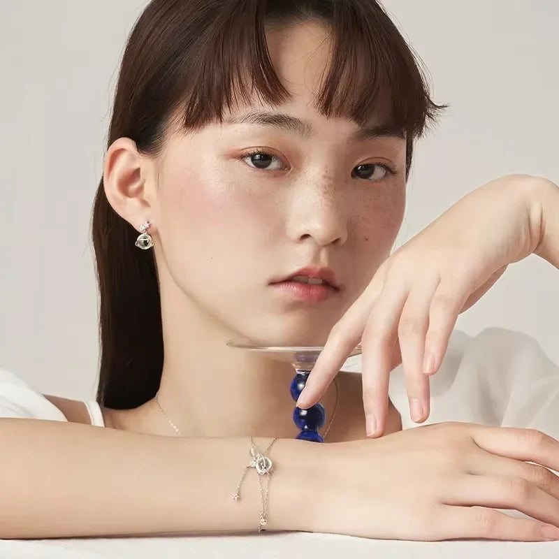 Rannekoru jossa kuukivihelmi ja zirkonium-tähtikoristeet