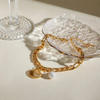 Naisten kampasimpukka- ja helmirannekoru