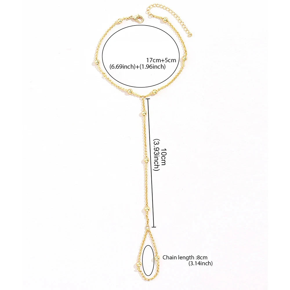 Naisten pallohelmillä koristeltu käsirannekoru, kultainen käsi- ja sormiketju