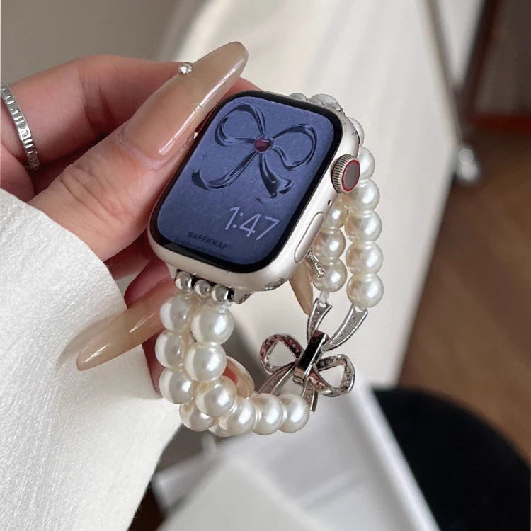 Korvaava ranneke Apple Watchille, jossa on strasseja ja valkoisia helmiä