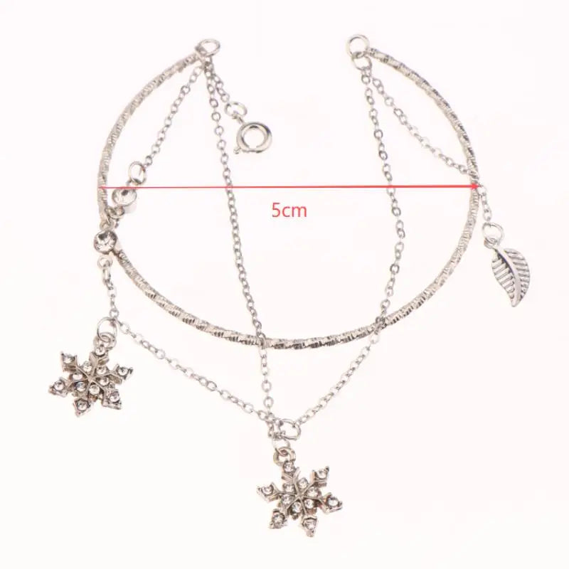 Kaksinkertainen rannekoru kristallilumihiutaleilla