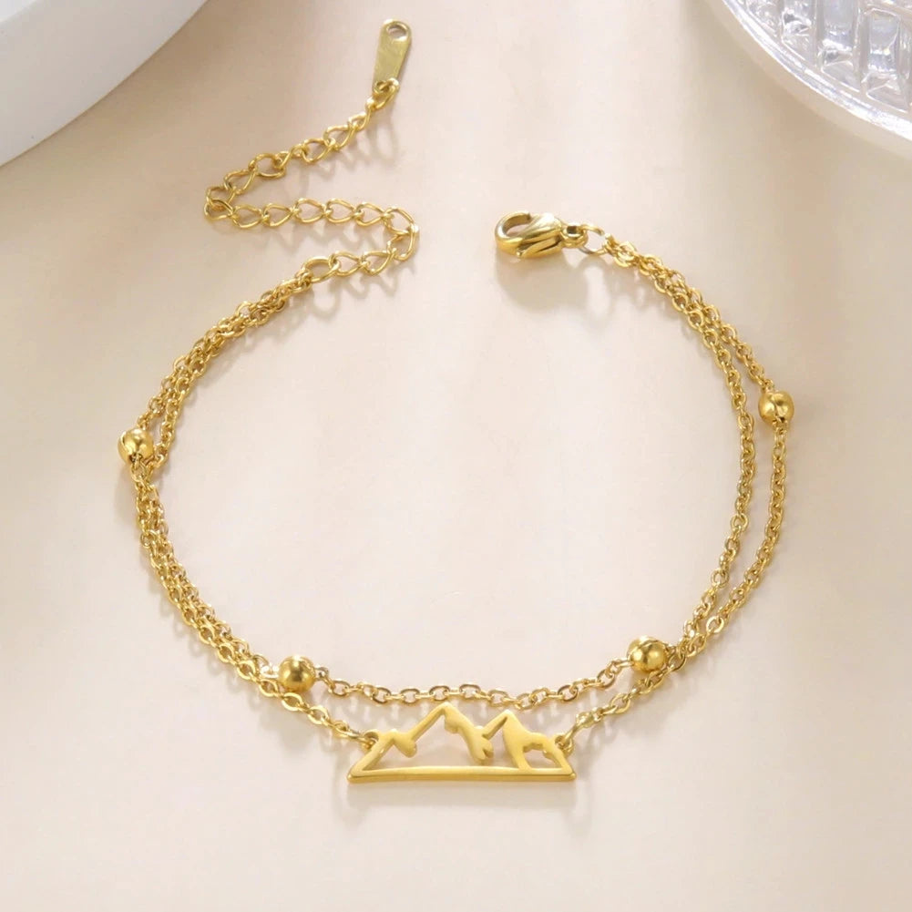 Kaksoisrannekoru vuoristoriipuksella kulta