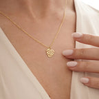 Kaulakoru kultaisella palmulehtiriipuksella