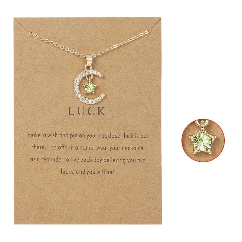 Kaulakoru, jossa on kuun muotoinen riipus ja syntymäkivi strassikoristein