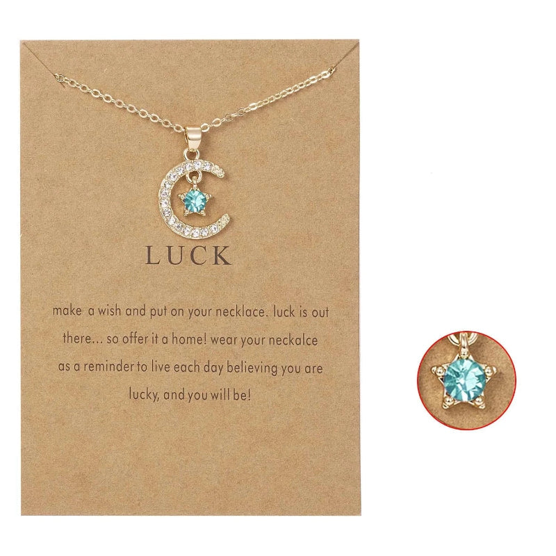 Kaulakoru, jossa on kuun muotoinen riipus ja syntymäkivi strassikoristein