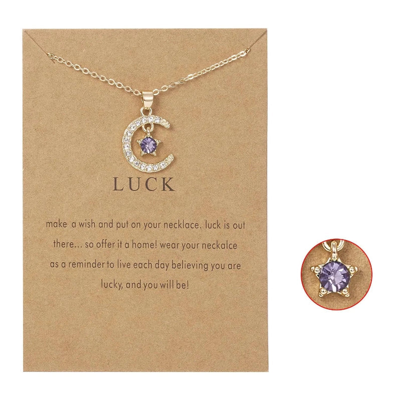 Kaulakoru, jossa on kuun muotoinen riipus ja syntymäkivi strassikoristein