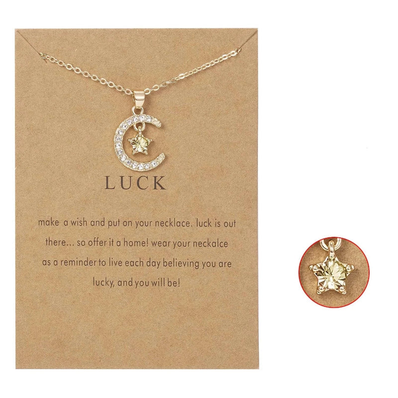 Kaulakoru, jossa on kuun muotoinen riipus ja syntymäkivi strassikoristein