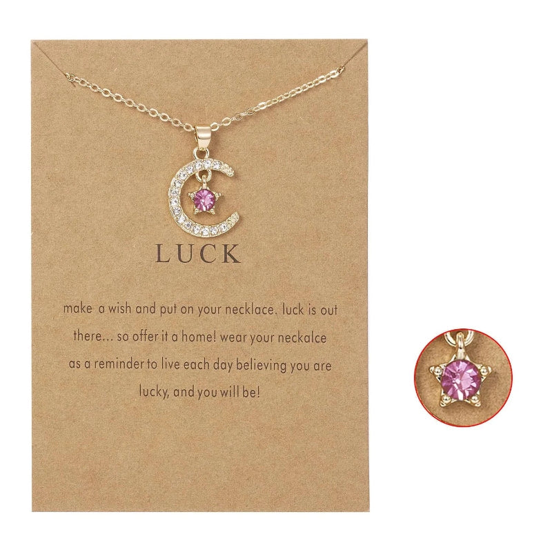 Kaulakoru, jossa on kuun muotoinen riipus ja syntymäkivi strassikoristein