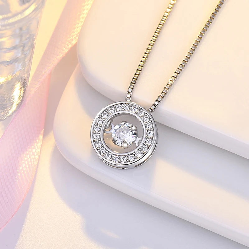 Kaulakoru, jossa on pyörivä stressiä lievittävä riipus ja zirkonia