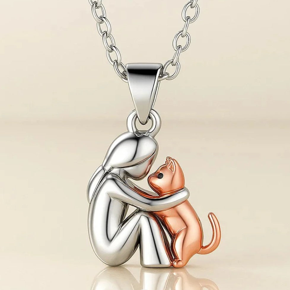 Rakastava kaulakoru, jossa on kissa ja omistaja halaamassa 