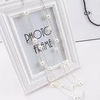 Pitkä kaksoiskaulakoru suurilla valkoisilla helmillä hopea