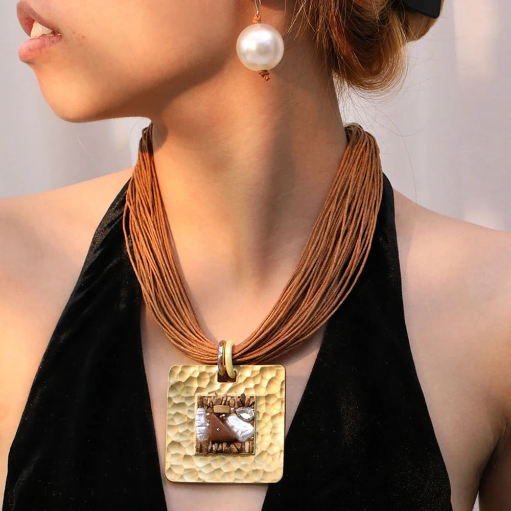 Nauhakorujen kaulakoru ruskealla neliönmuotoisella riipuksella