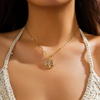 Elämänpuu-riipus kaulakorussa, jossa kristalli