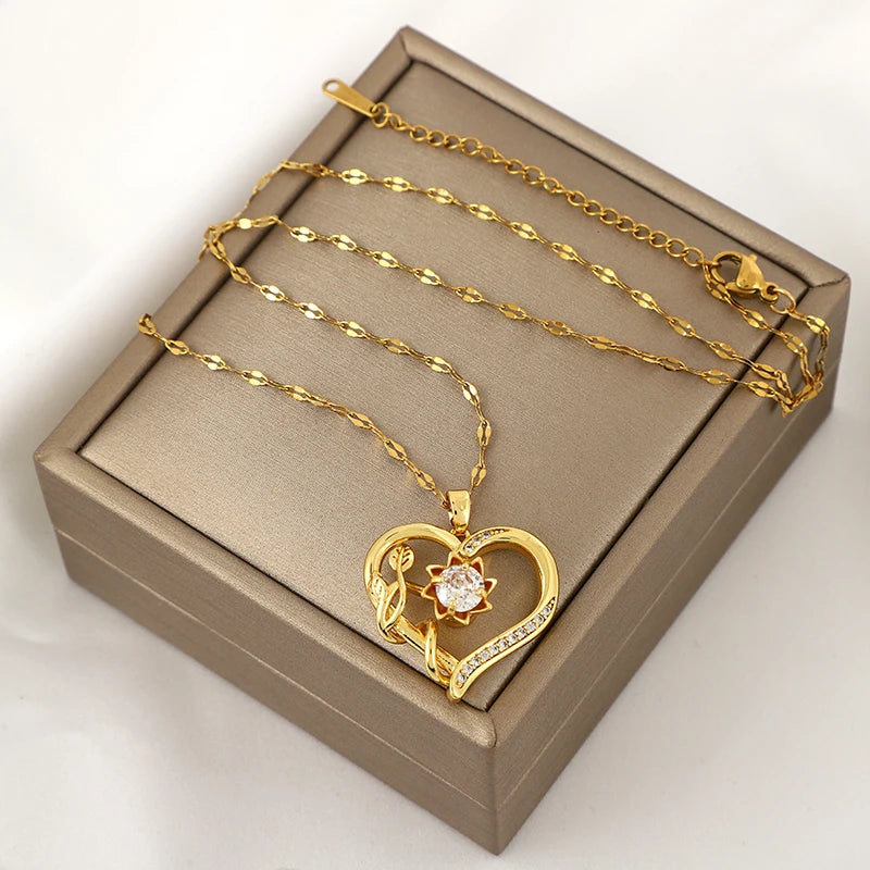 Kaulakoru, jossa sydän- ja kukkariipus, pyörivä stressinpoistaja