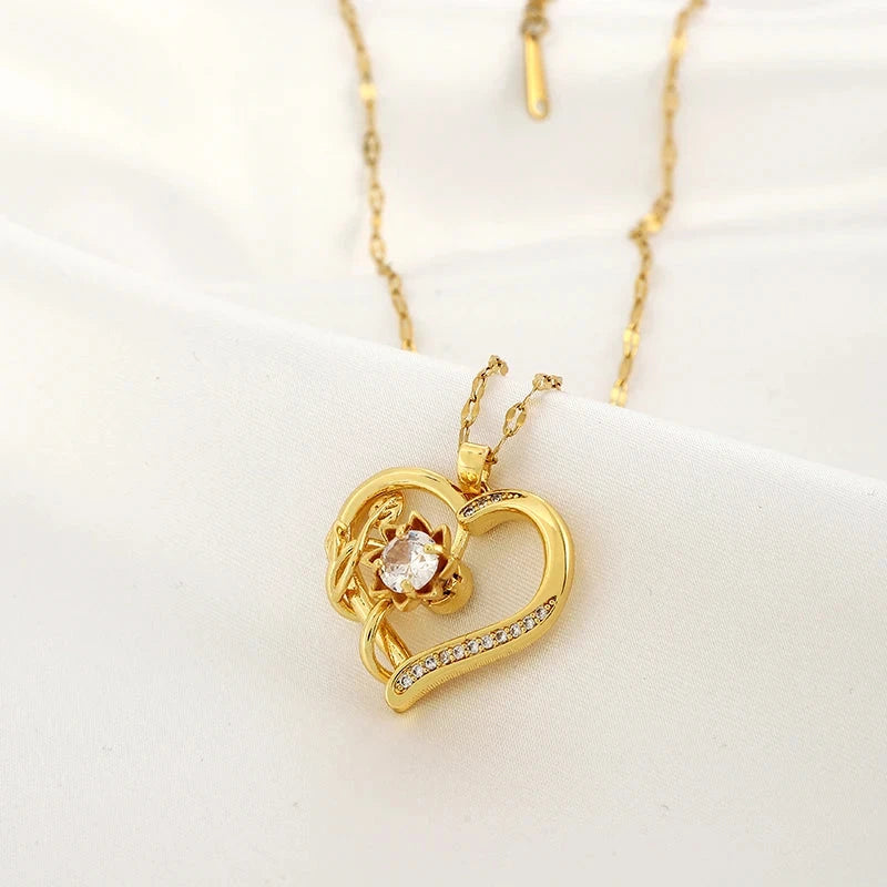 Kaulakoru, jossa sydän- ja kukkariipus, pyörivä stressinpoistaja