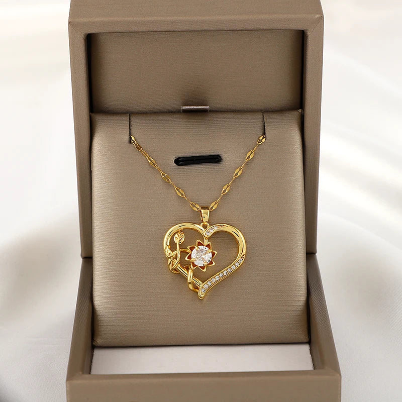 Kaulakoru, jossa sydän- ja kukkariipus, pyörivä stressinpoistaja