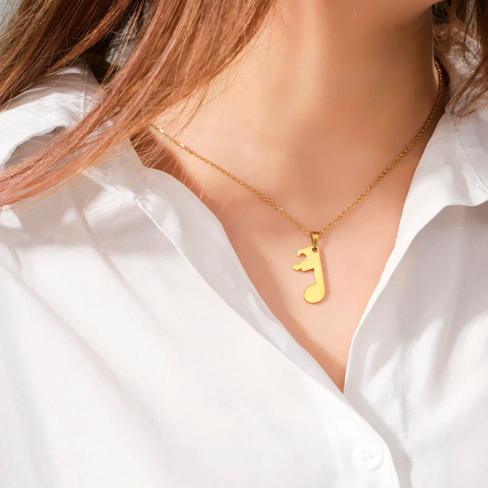 Pariskuntien kaulakorut kultainen nuottiriipus