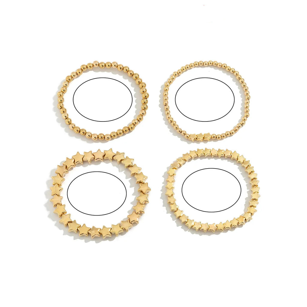 Setti, jossa 4 kultaiset tähtirannekorut