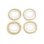 Setti, jossa 4 kultaiset tähtirannekorut